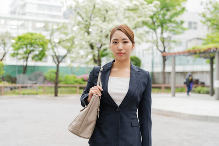 Asian businesswoman commuting outdoorsの写真素材