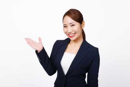 Asian woman in formal wear with showing poseの写真素材