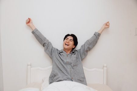Japanese man get up from bedの写真素材