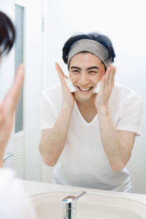 Japanese man washing his faceの写真素材