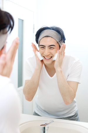 Japanese man washing his faceの写真素材
