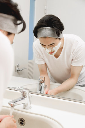 Japanese man washing his faceの写真素材