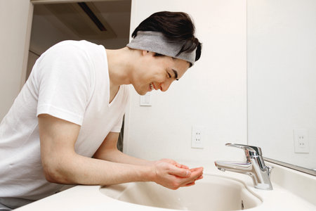 Japanese man washing his faceの写真素材