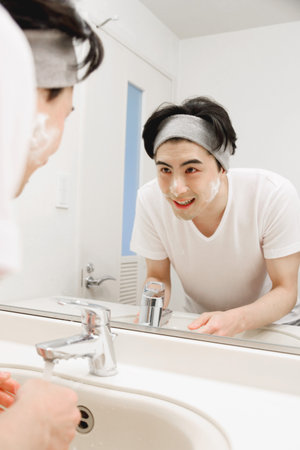 Japanese man washing his faceの写真素材