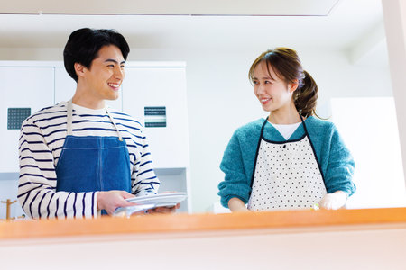 Japanese couple in kitchenの写真素材