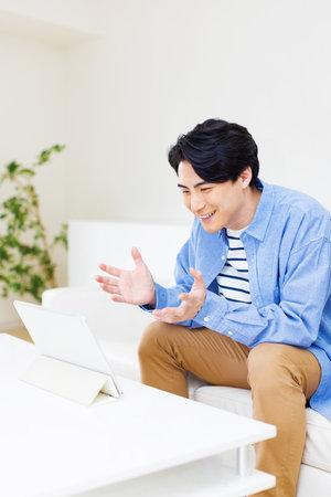 Japanese man watching digital tabletの写真素材
