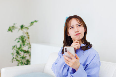 Japanese woman working at homeの写真素材