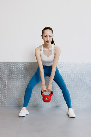 Young Asian woman with a kettlebellの写真素材