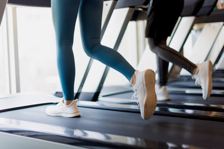 People running on treadmills at gymの写真素材