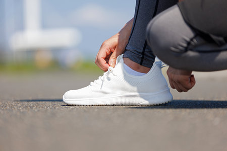 Close up of man tying shoelaceの写真素材