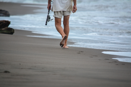 man fishing on the beachの写真素材