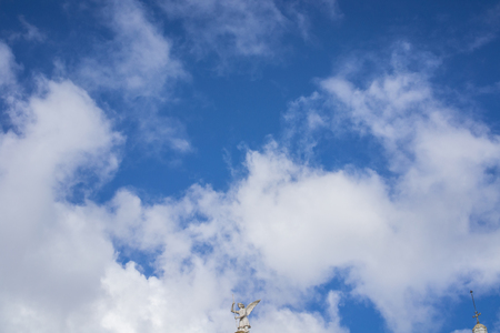 statue in bluish sky with cloudsの写真素材