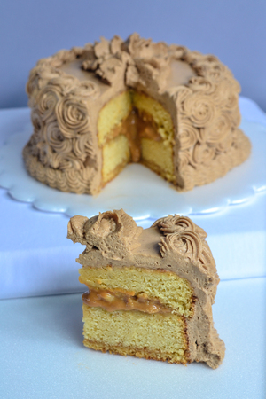 birthday cake of sweet milk with a pieceの写真素材