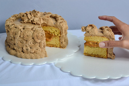 birthday cake of sweet milk with a pieceの写真素材