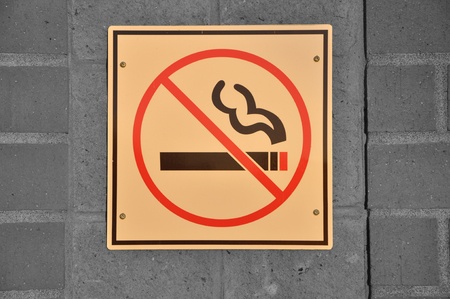 No smoking sign on wall with sunset light on signの写真素材