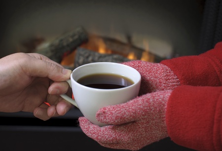 Hand warming at a fireplace