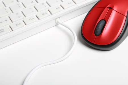 Red mouse and keyboard on white backgroundの写真素材