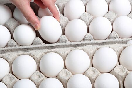 Macro woman hand picking a egg