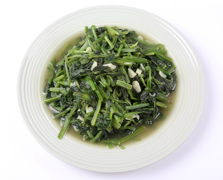 Cooked spinach on white dishの写真素材