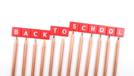 Back to school text and crayons over white background