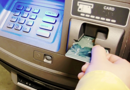 Woman insert card to withdraw money の写真素材