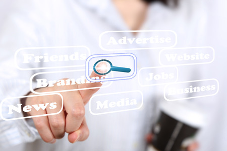Business woman pressing search buttonの写真素材