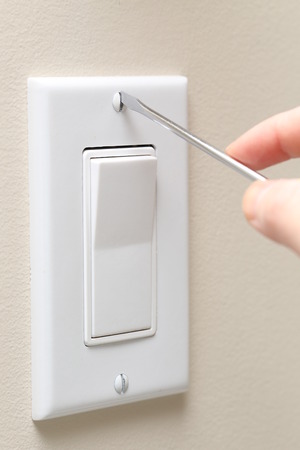 Man repaires a wall socket 