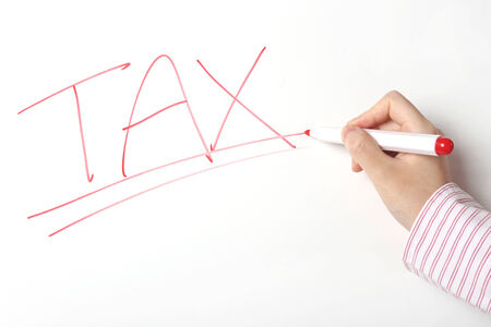 Business woman writing tax word on whiteboardの写真素材