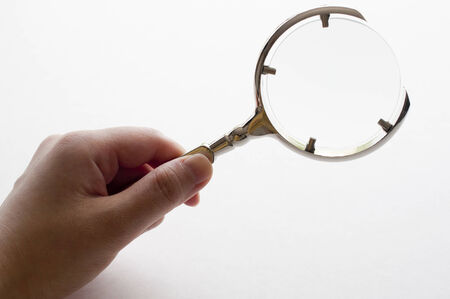 Woman's hand holding magnifying glassの写真素材