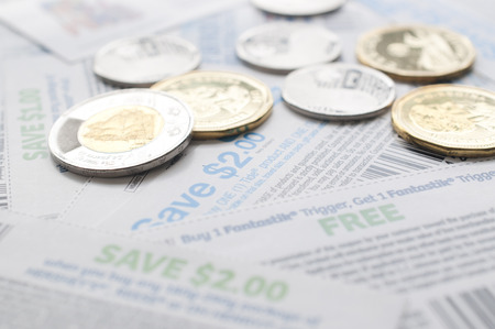 Coquitlam BC Canada - July 22, 2014 : Canadian saving coupons with money, focus on two dollar saving...