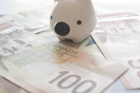 Piggy bank on Canadian money backgroundの写真素材