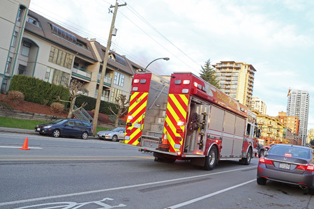 Coquitlam, BC, Canada - February 16, 2015 : A firetruck stopped on a street in Coquitlam BC Canada..