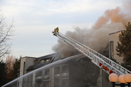 Coquitlam, BC, Canada - February 16, 2015 : Firefighter crews battling apartment complex fire on Glen drive in Coquitlam.のeditorial素材