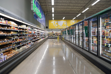 Port Coquitlam BC Canada - March 16, 2015 : Dairy and fozen food corridor in Save on Foods. It is a regional chain of supermarkets located in British Columbia, Canada.のeditorial素材