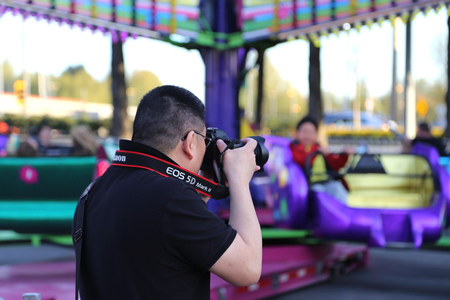 Coquitlam, BC, Canada - April 09, 2015 : People having fun at the West Coast Amusements Carnivalのeditorial素材