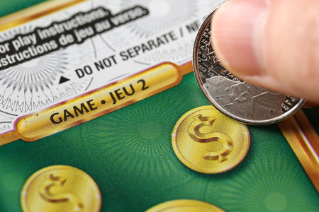 Coquitlam BC Canada - June 02, 2015 : Woman scratching lottery ticket. The British Columbia Lottery Corporation has provided government sanctioned lottery games in British Columbia since 1985.のeditorial素材