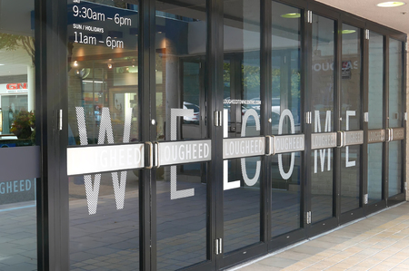 Burnaby, BC, Canada - July 11, 2016 : One side of mall entrance with welcome sign on door in Lougheed Town Centre mallのeditorial素材