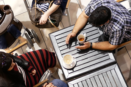 Coquitlam, BC, Canada - April 12, 2017 : Top shot of customer drinking coffee and chatting with friend inside Coquitlam shopping mallのeditorial素材