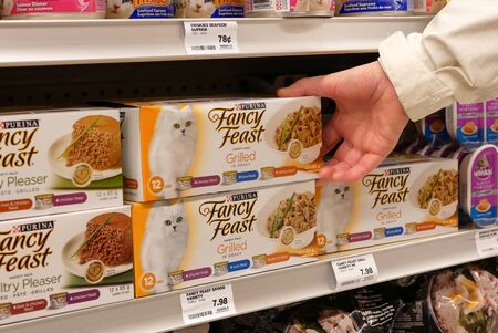 Coquitlam, BC, Canada - April 26, 2017 : Woman buying Purina fancy feast variety pack inside London drugs storeのeditorial素材