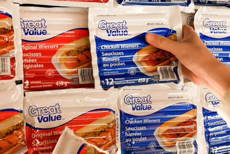 New Westminster, BC, Canada - April 26, 2017 : Woman buying Great value original and chicken wieners inside Walmart storeのeditorial素材
