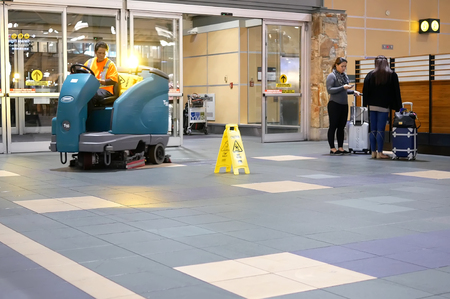 Vancouver, BC, Canada - October 13, 2017 : Motion of airport workers cleaning floor during night inside YVR airport in Vancouver BC Canadaのeditorial素材