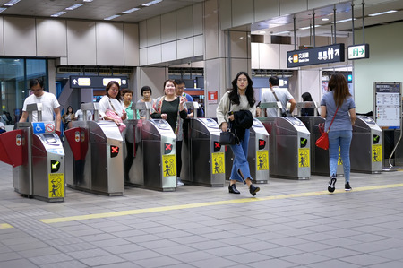 Taipei, Taiwan - October 31, 2017 : Motion of people walking through the fare pay zone for taking...