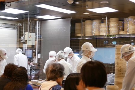 Taipei, Taiwan - November 02, 2017 : Motion of people are kneading the dough and shaping it with their hands to make dumplings with customer in front of window while waiting to restaurant.のeditorial素材
