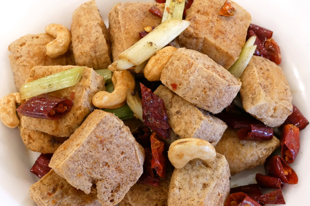 Top shot of fried stinky tofu on table inside restaurantの写真素材