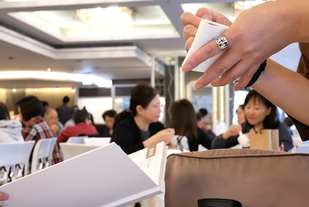 Taipei, Taiwan - December 01, 2017 : Motion of waitress taking customer order with people enjoy meal inside restaurantのeditorial素材