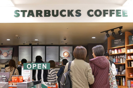 Taipei, Taiwan - December 24, 2017 : Motion of people line up for buying coffee at Starbucks store inside shopping mall in Taipei Taiwanのeditorial素材