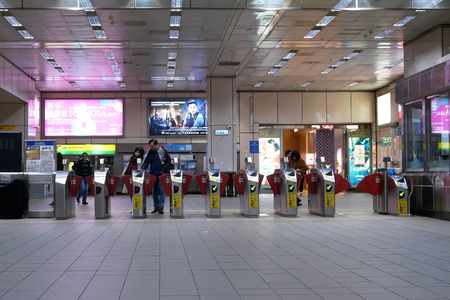 Taipei, Taiwan - December 29, 2018 : Motion of people walking through the fare of pay zone and...