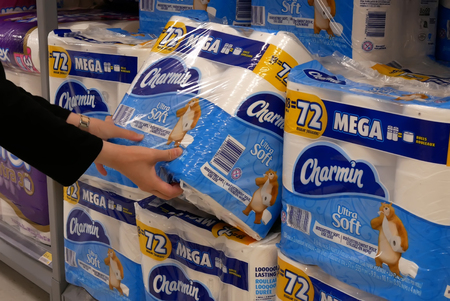 Motion of woman buying charmin bathroom tissue inside Walmart store