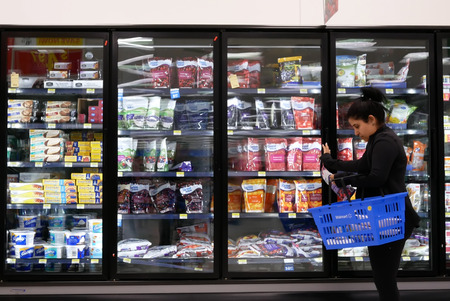 Motion of woman buying frozen fruits inside Walmart store