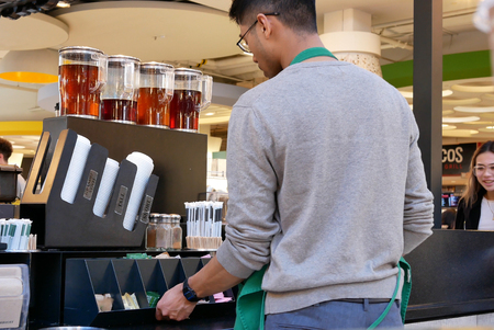 Motion of worker filling sugar on table inside Starbucks storeのeditorial素材